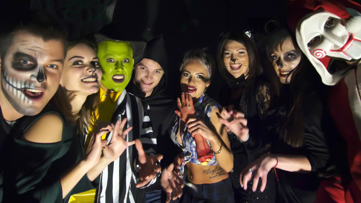 Junge Menschen in Halloween-Kostümen auf einer Party.