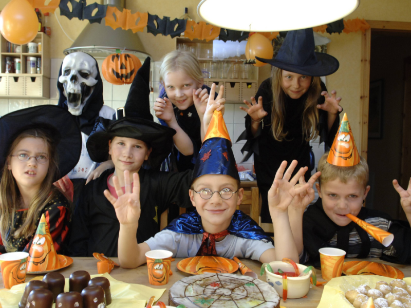 Verkleidete Kinder mit gruseligen Kostümen auf einer Halloween-Kinderparty