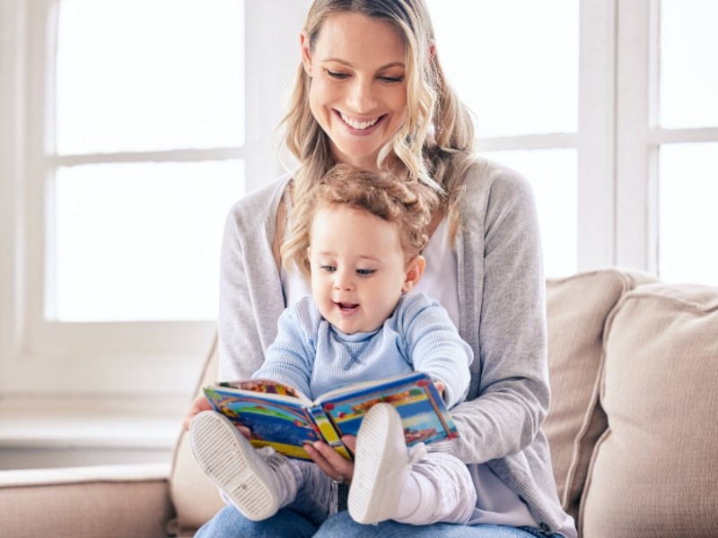 Mutter guckt sich mit ihrem Sohn ein Buch an